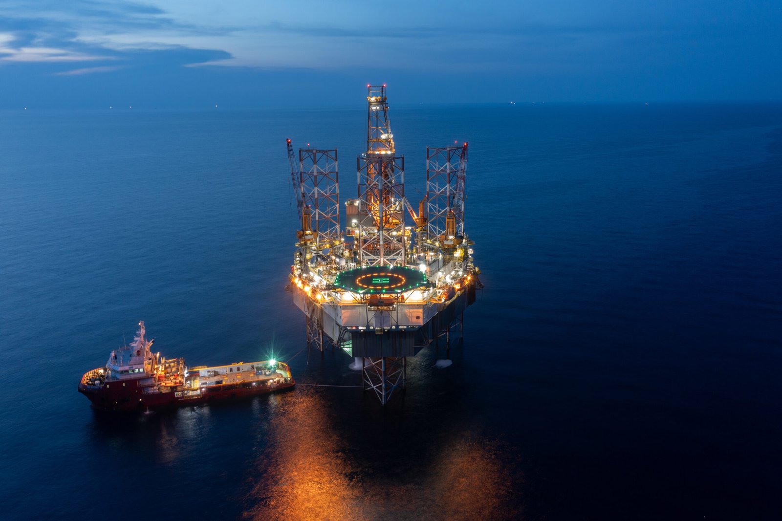 Aerial view of offshore jack up drilling rig during sunset - oil and gas industry