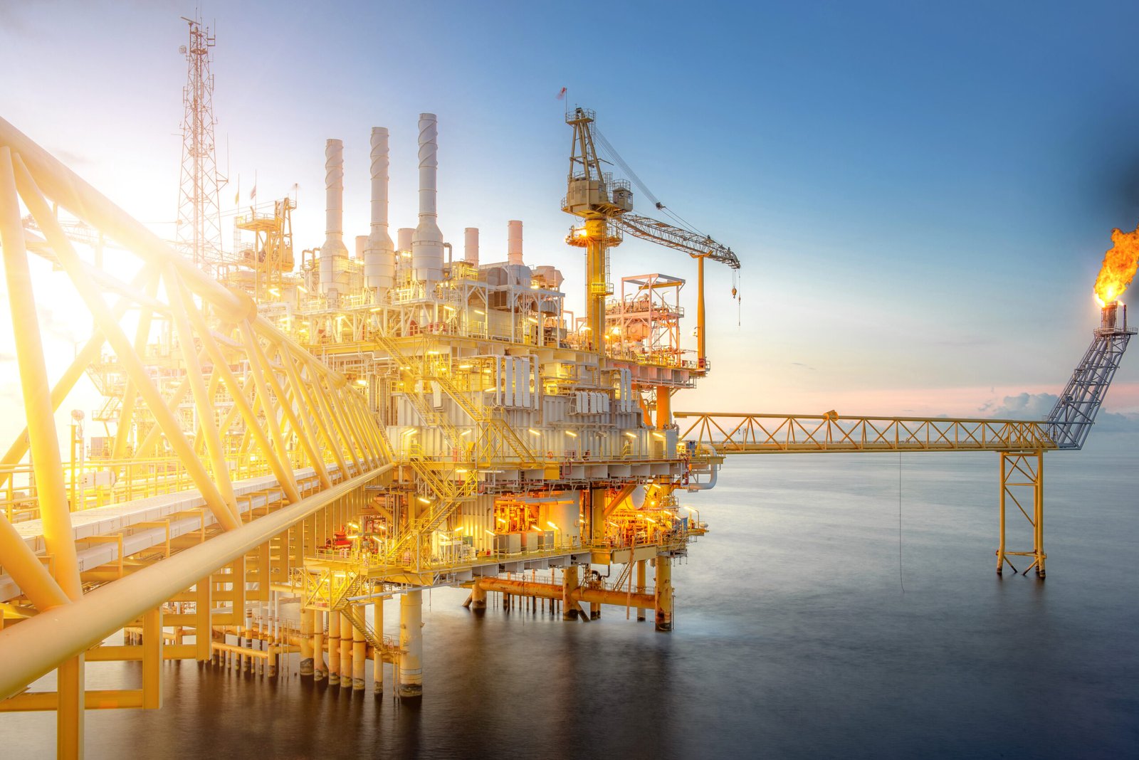 Large offshore drilling oil rig plant in the gulf at twilight